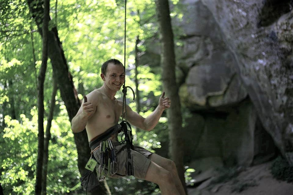 John Being lowered from a climbing route